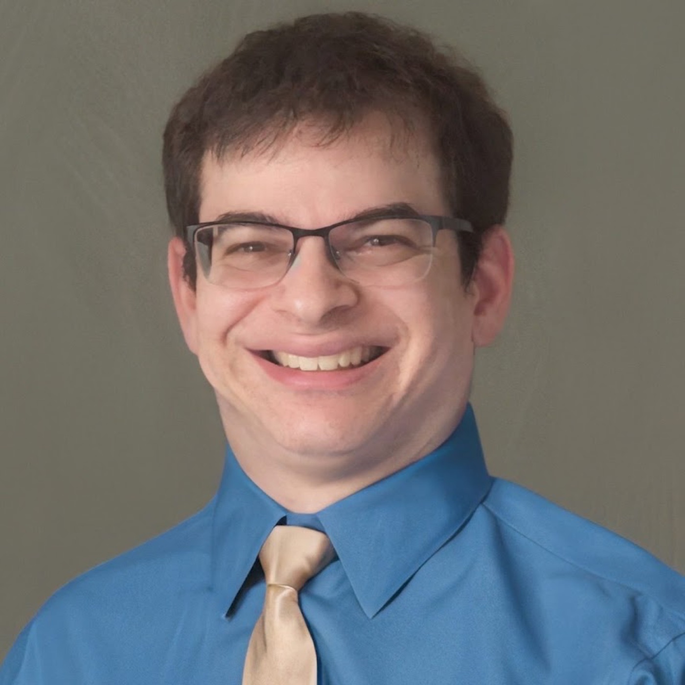 Ryan Honick smiling in a blue shirt and tie